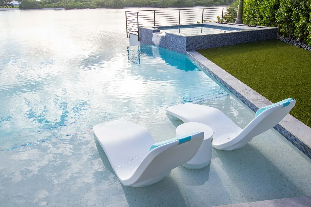 White Tenjam chaise loungers on a pool tanning ledge