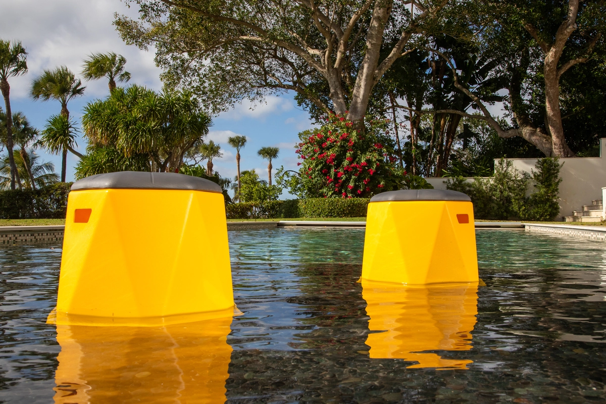 Yellow Tenjam stools in a swimming pool